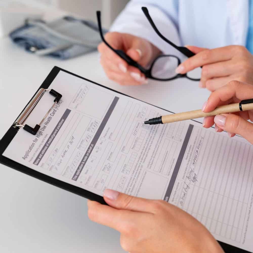side view patient filling consent document - Stem Cells Costa Rica